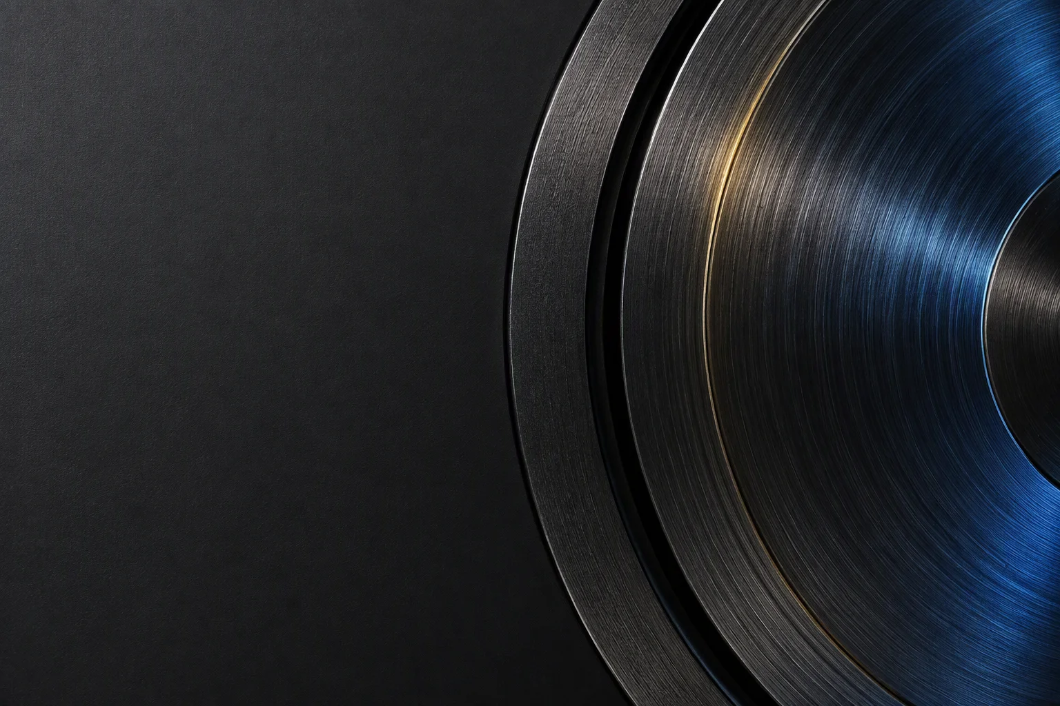 A precision bearing ring photographed in macro on a dark ground, the ground raceway and the chamfer catching a raking light